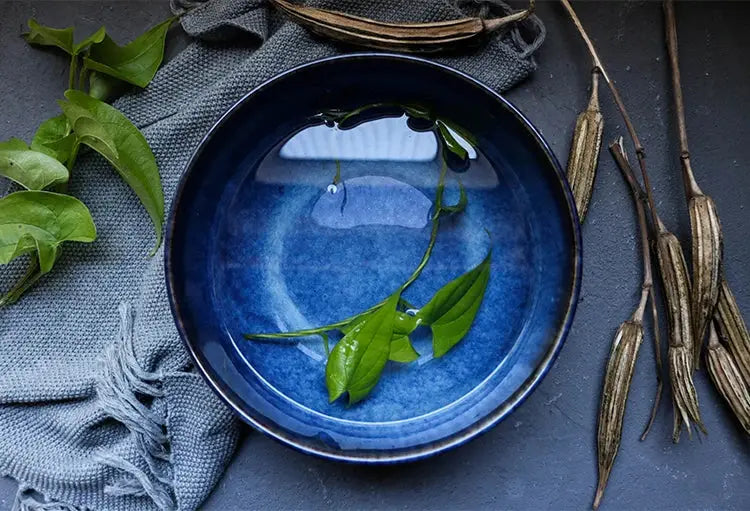 A handcrafted ceramic Kaia bowl in a subtle blue shade, ideal for serving sushi, ramen, and miso soup, showcasing its elegant and minimalist design.