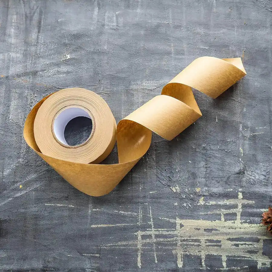 Eco-friendly Kraft Paper Tape on a roll, showcasing its natural texture and water-activated adhesive properties.