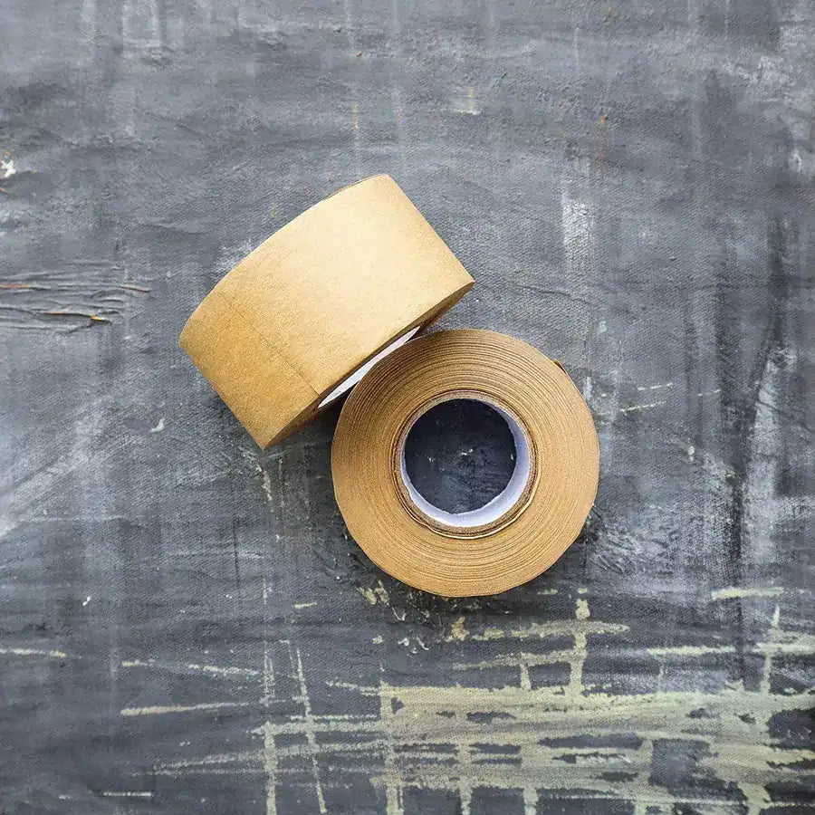 Eco-friendly Kraft Paper Tape on a roll, showcasing its natural texture and water-activated adhesive properties.