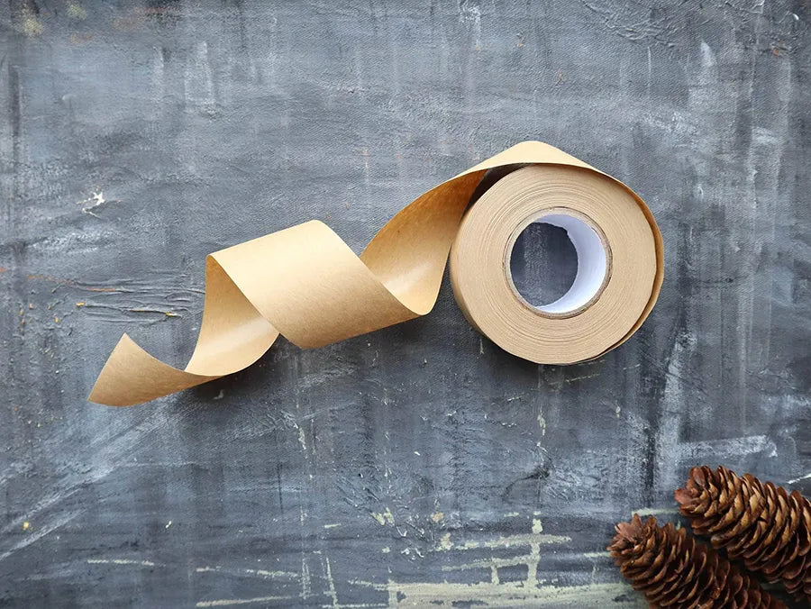 Eco-friendly Kraft Paper Tape on a roll, showcasing its natural texture and water-activated adhesive properties.