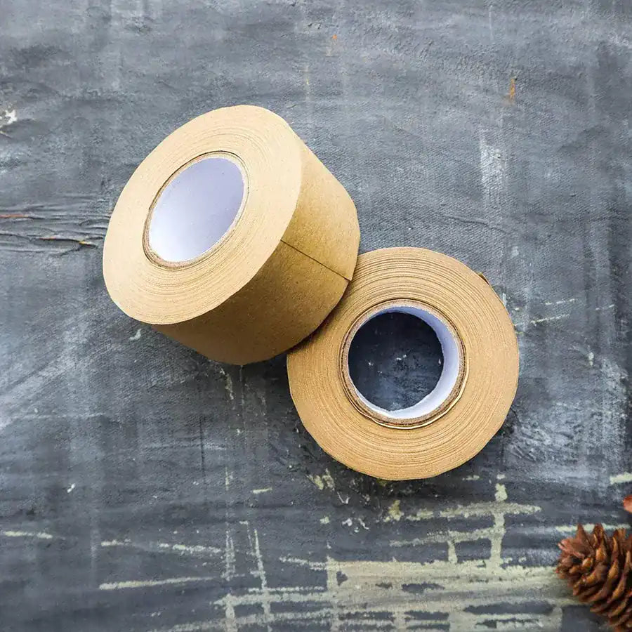 Eco-friendly Kraft Paper Tape on a roll, showcasing its natural texture and water-activated adhesive properties.