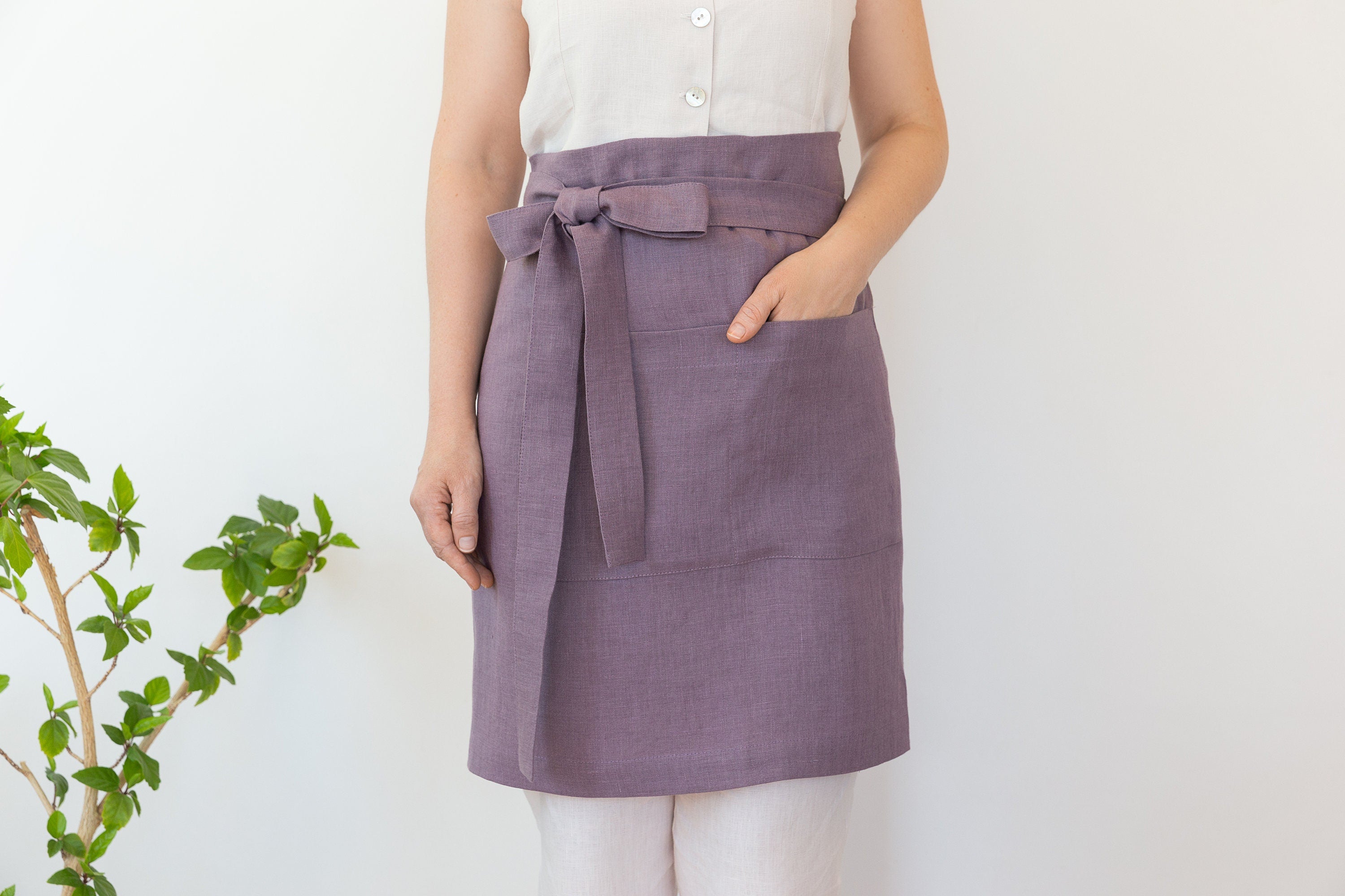 Lemon linen waist apron with pockets and ties, showcasing its vibrant color and soft texture, perfect for kitchen use.