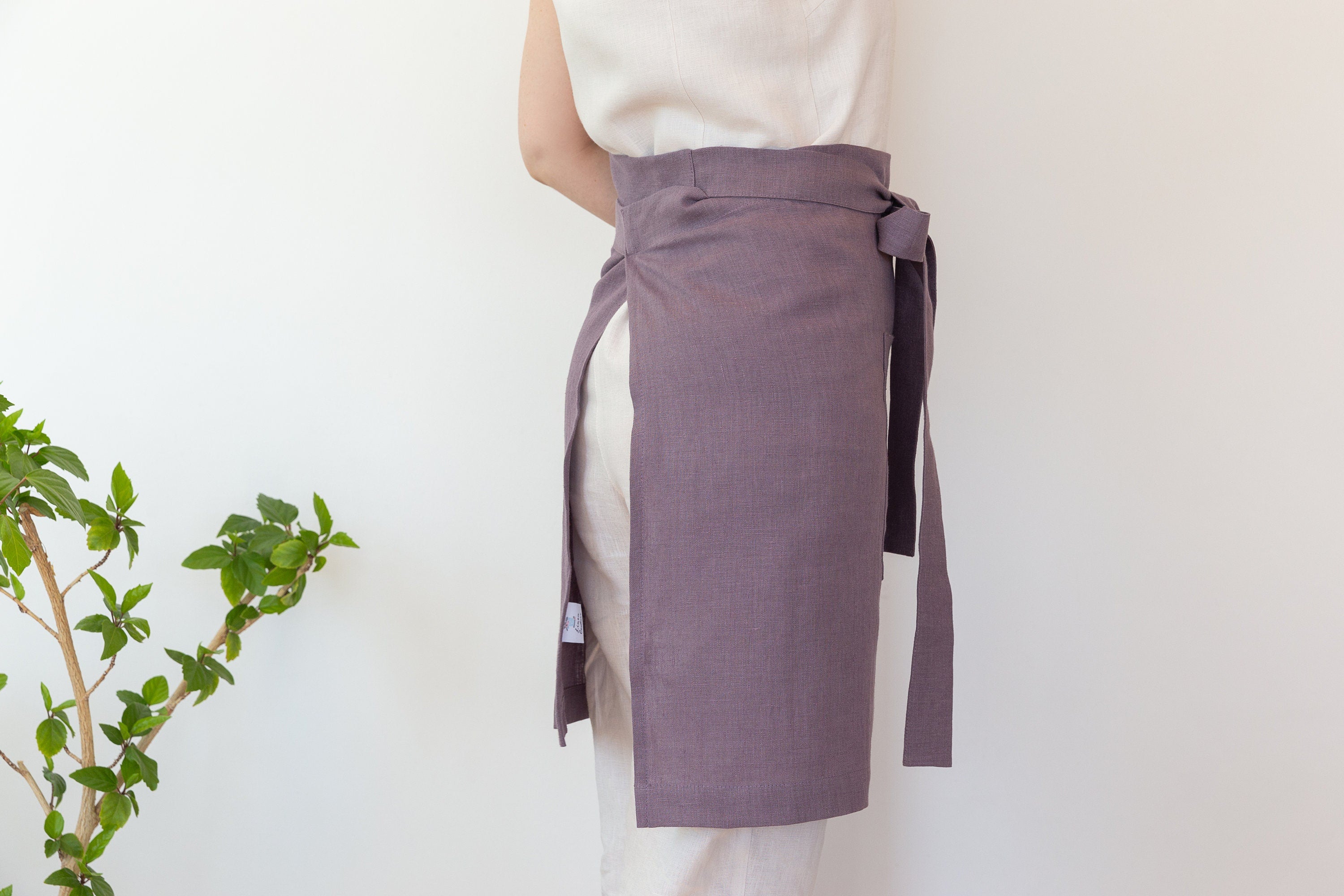 Lemon linen waist apron with pockets and ties, showcasing its vibrant color and soft texture, perfect for kitchen use.