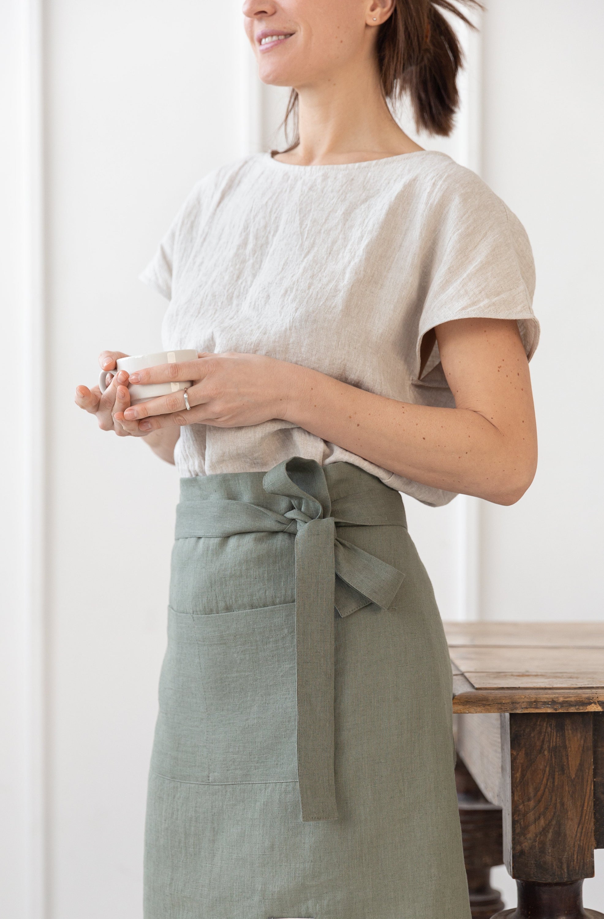 Lemon linen waist apron with pockets and ties, showcasing its vibrant color and soft texture, perfect for kitchen use.