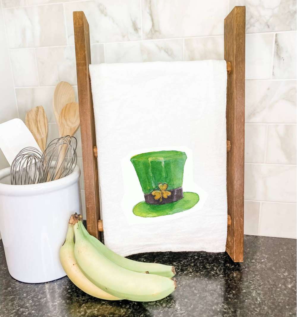 A vibrant cotton tea towel featuring a whimsical leprechaun hat design, perfect for festive kitchen decor.