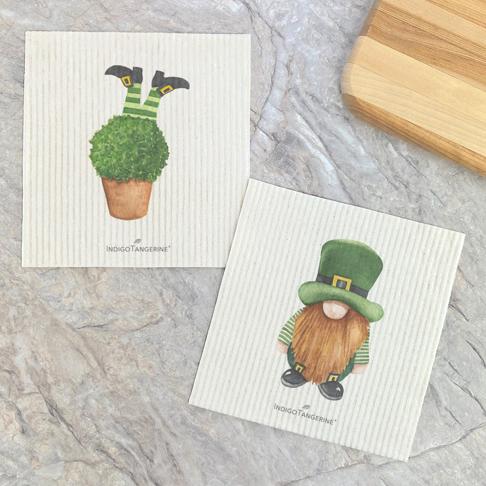 Two eco-friendly Swedish dish cloths featuring a leprechaun design, made from plant-based fibers.