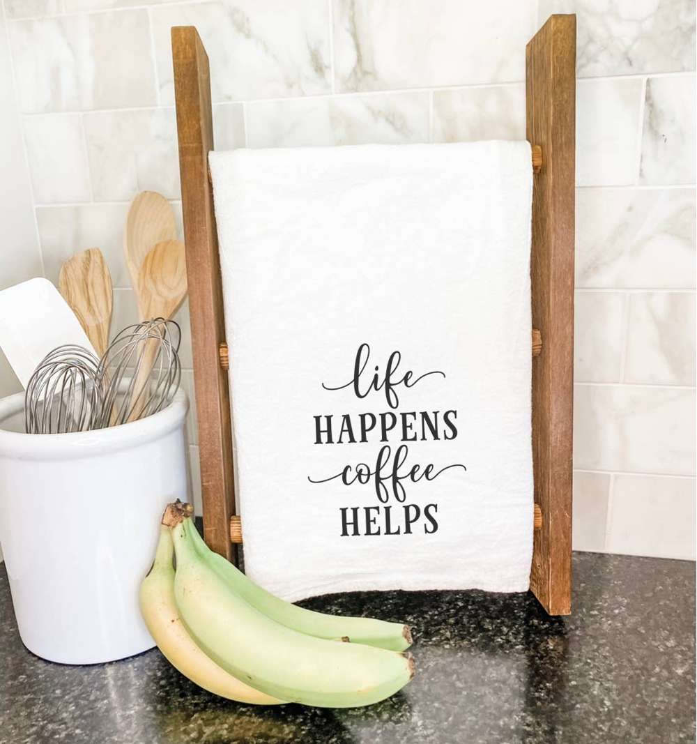 Life Happens Coffee Helps cotton tea towel featuring a vibrant design, made from 100% absorbent cotton, measuring 27 inches square.