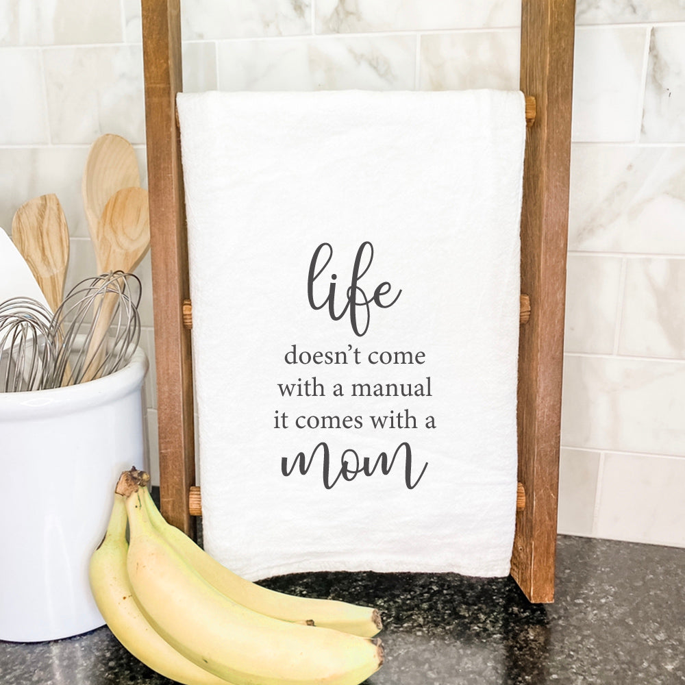 Kitchen towel reads inspirational quote.