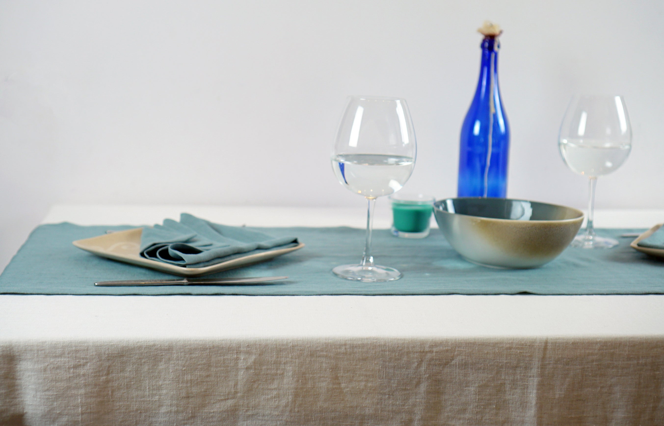 Elegant linen tablecloths in various colors and sizes, showcasing high-quality European linen with a decorative hem.