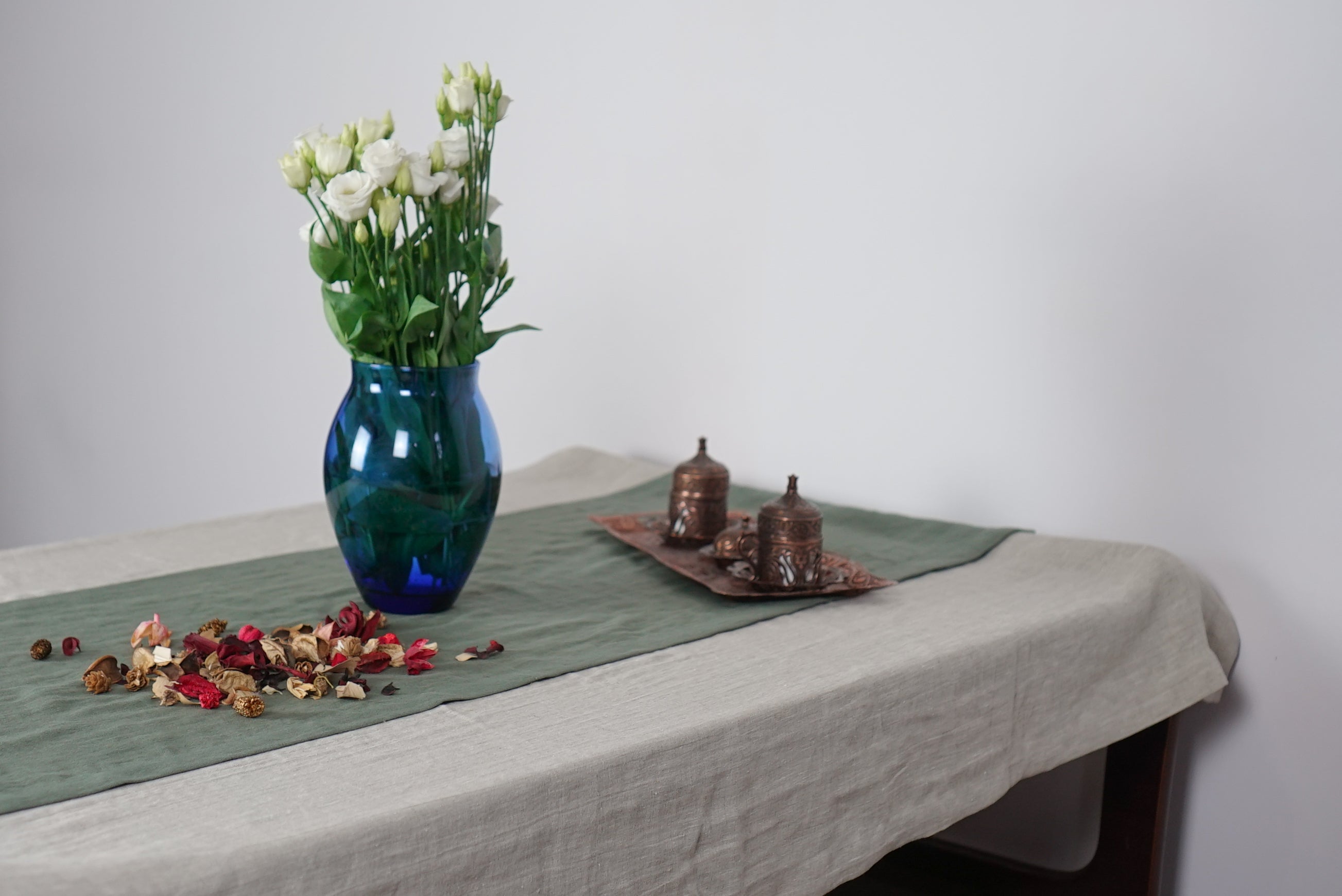 Elegant linen tablecloths in various colors and sizes, showcasing high-quality European linen with a decorative hem.