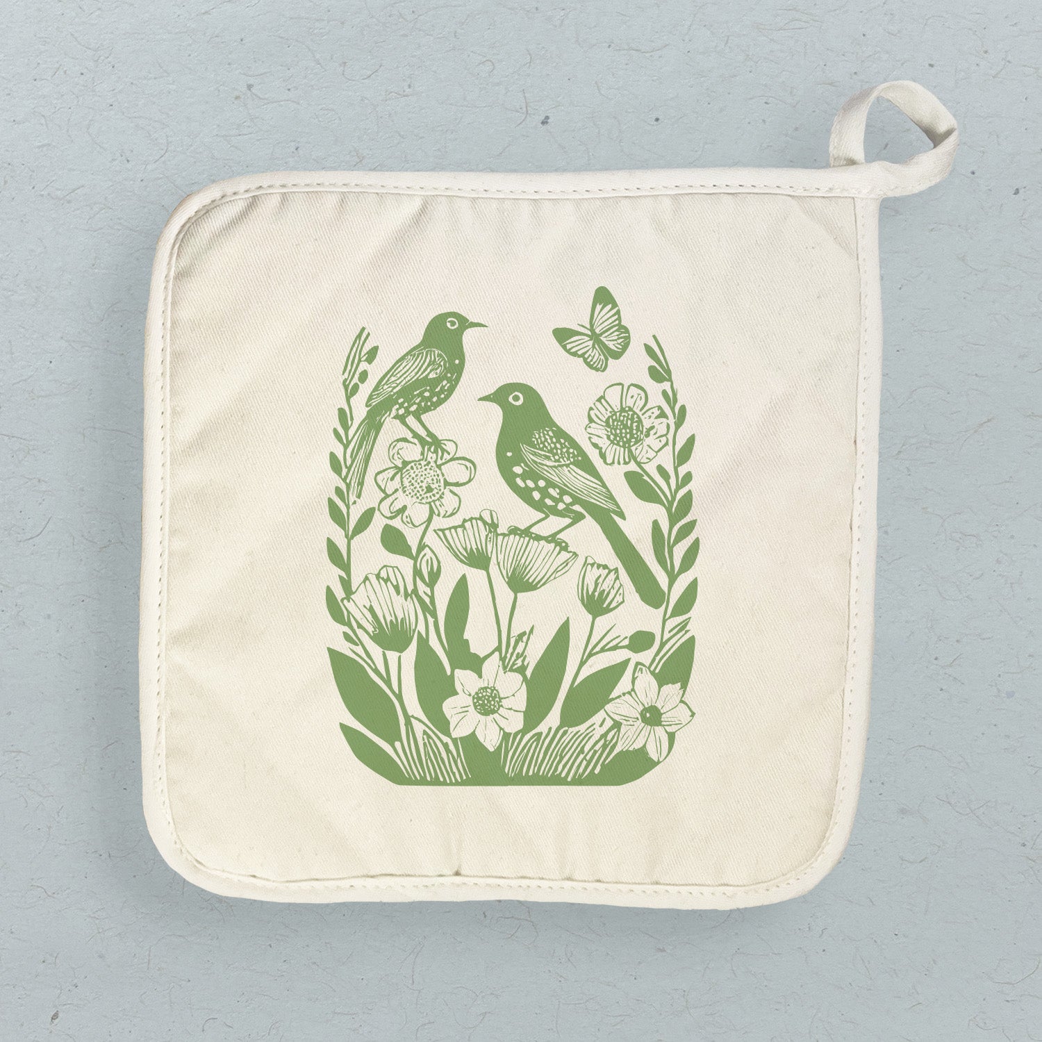 A beautifully designed Linocut Spring Birds cotton pot holder featuring vibrant bird prints, perfect for protecting surfaces from hot cookware.