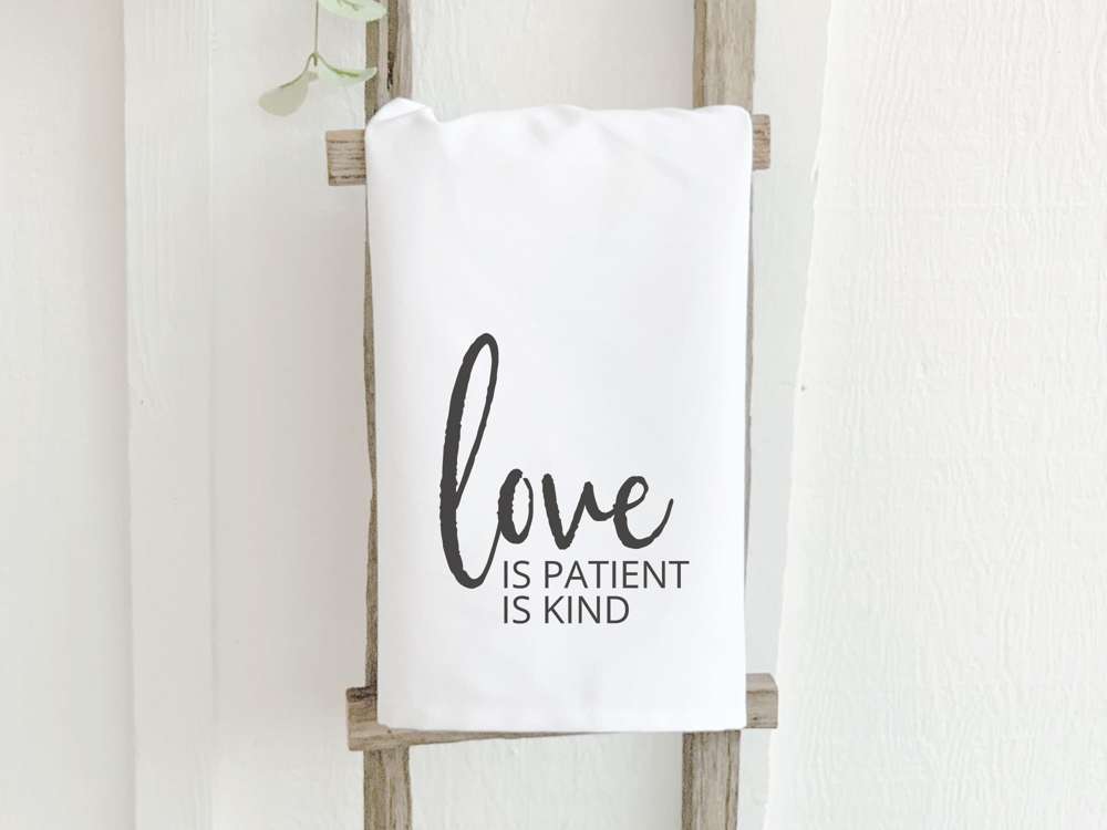 Love Is Patient cotton tea towel featuring a vibrant design, made from 100% absorbent cotton, measuring 27 inches square.