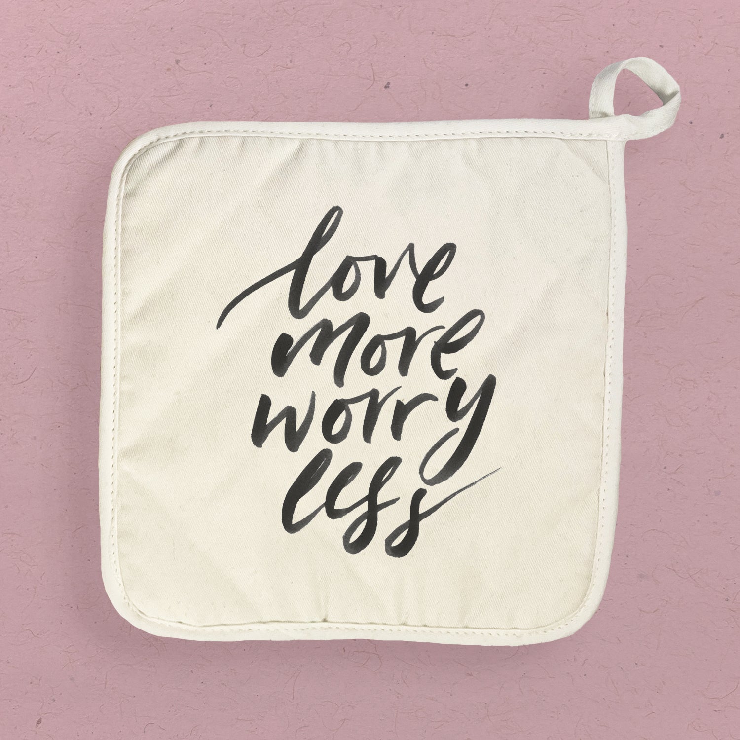 Love More Worry Less cotton pot holder featuring vibrant designs and a convenient hanging loop, perfect for kitchen use.