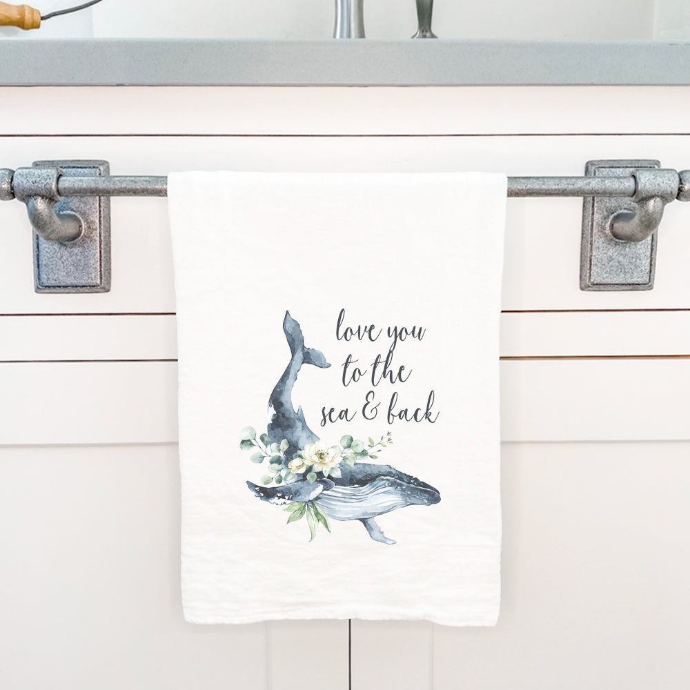 A vibrant cotton tea towel featuring a beautiful whale design, perfect for kitchen use.