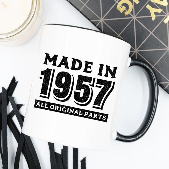 A humorous coffee mug featuring the text 'Made In 1957, All Original Parts - Funny Coffee Mug', showcasing a vibrant design perfect for 61st birthday celebrations.