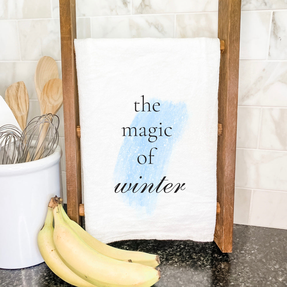 Magic of Winter cotton tea towel featuring a vibrant winter design, made from 100% absorbent cotton, measuring 27 inches square.