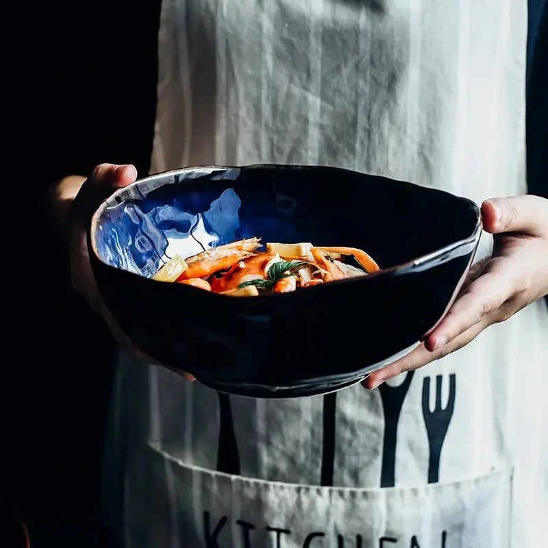 Maana Bowl featuring dark blue ceramic with golden stripes, elegantly designed for serving and decoration.