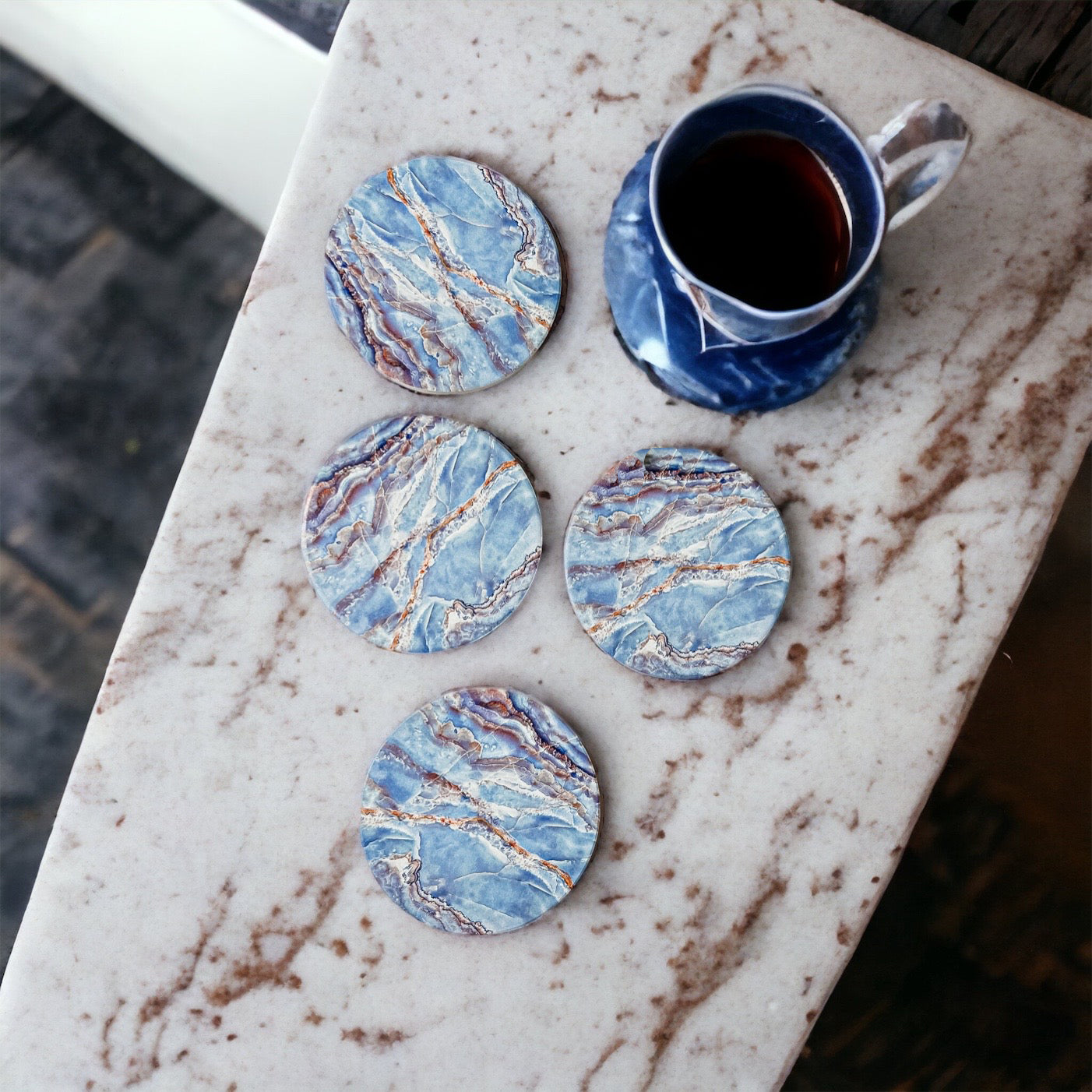 Set of four luxurious Marble Blue Coasters with a watercolor effect, featuring shades of blue and gold accents, displayed in a brown box.