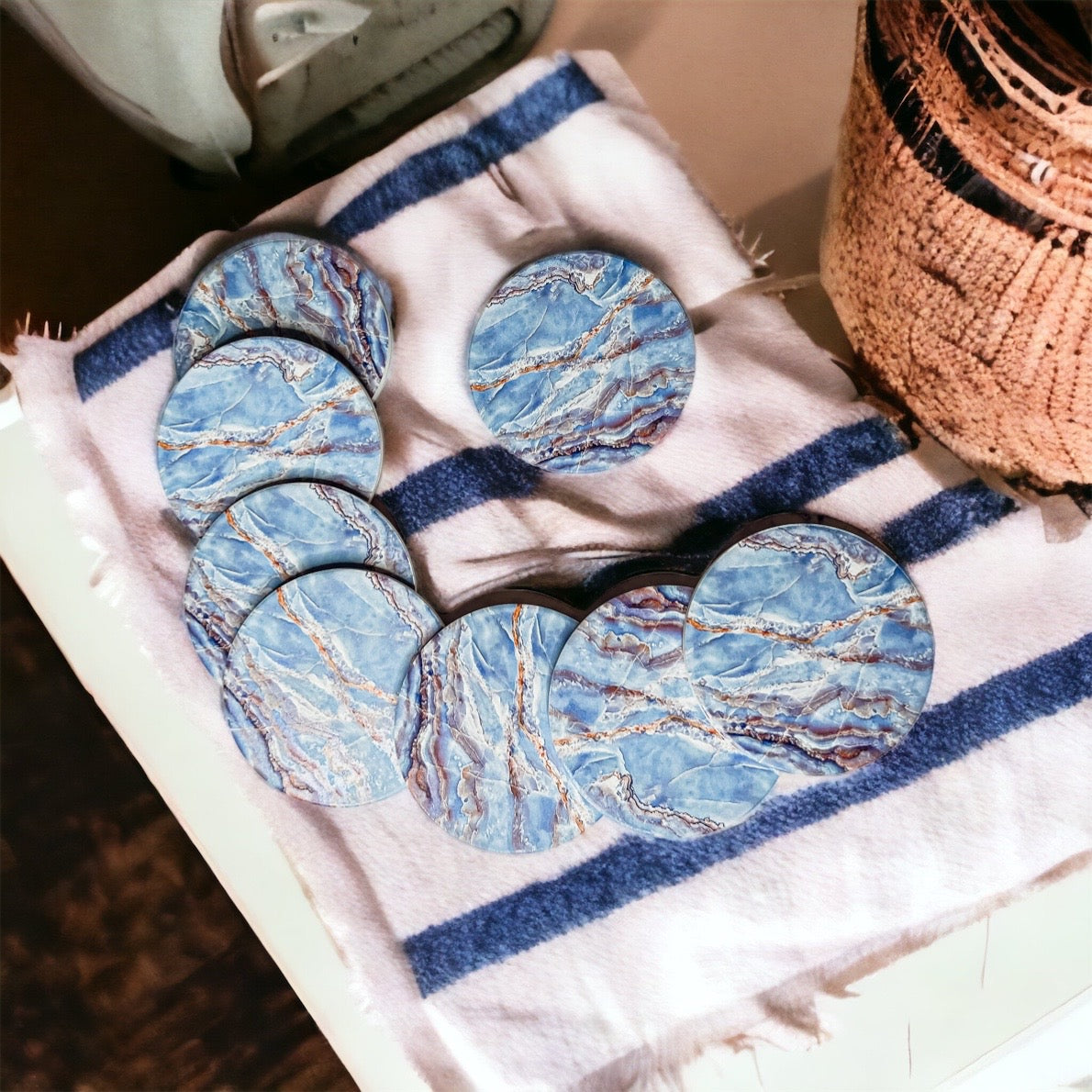 Set of four luxurious Marble Blue Coasters with a watercolor effect, featuring shades of blue and gold accents, displayed in a brown box.