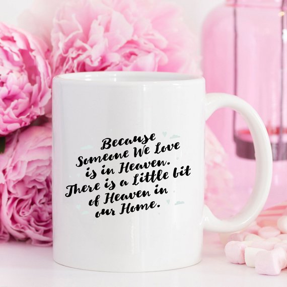 A personalized sympathy gift mug featuring a humorous design that reads 'There Is A Little Bit Of Heaven In Our Home', made from high-quality ceramic.