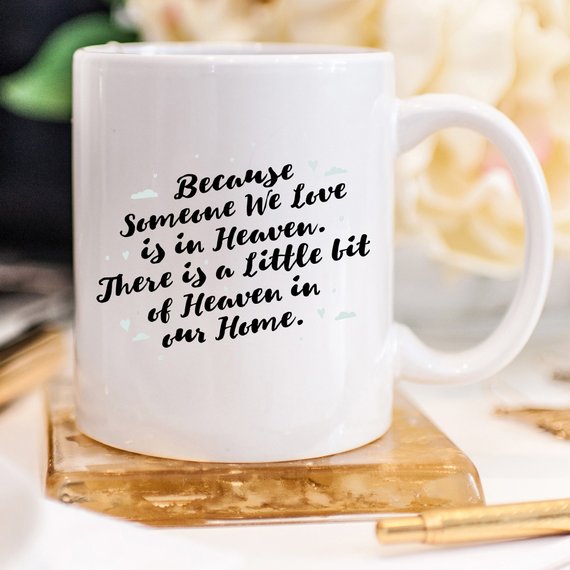 A personalized sympathy gift mug featuring a humorous design that reads 'There Is A Little Bit Of Heaven In Our Home', made from high-quality ceramic.