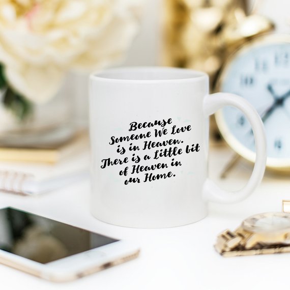 A personalized sympathy gift mug featuring a humorous design that reads 'There Is A Little Bit Of Heaven In Our Home', made from high-quality ceramic.