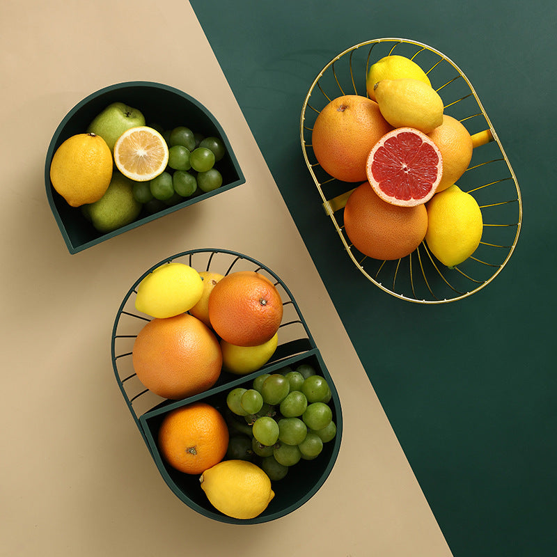 A stylish metal hollowed out fruit and vegetable snack tray bowl basket in dark green and gold, showcasing a variety of fresh fruits and snacks.