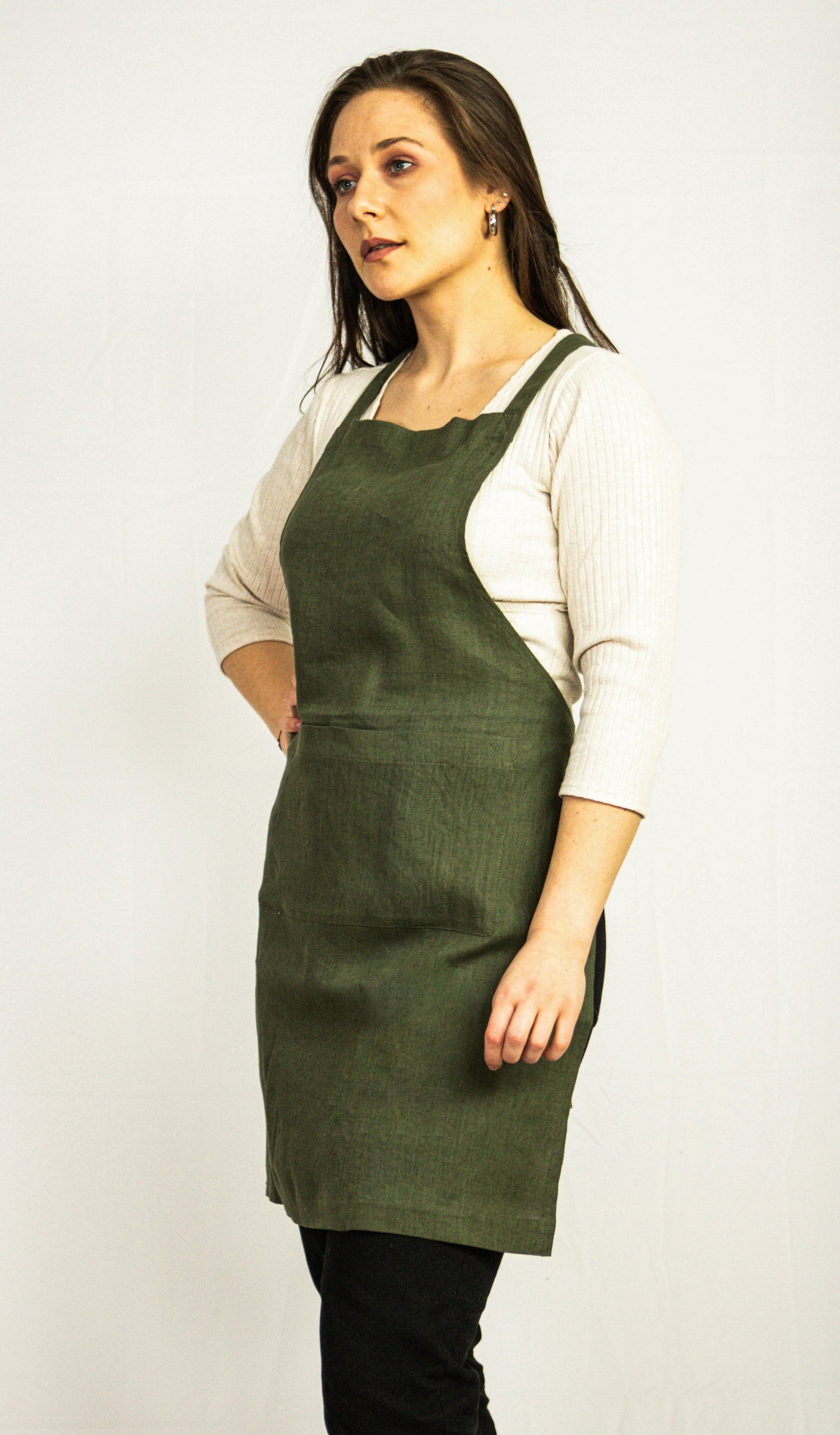 Moss Green linen apron with adjustable back ties and front pockets, showcasing its elegant design and functionality.