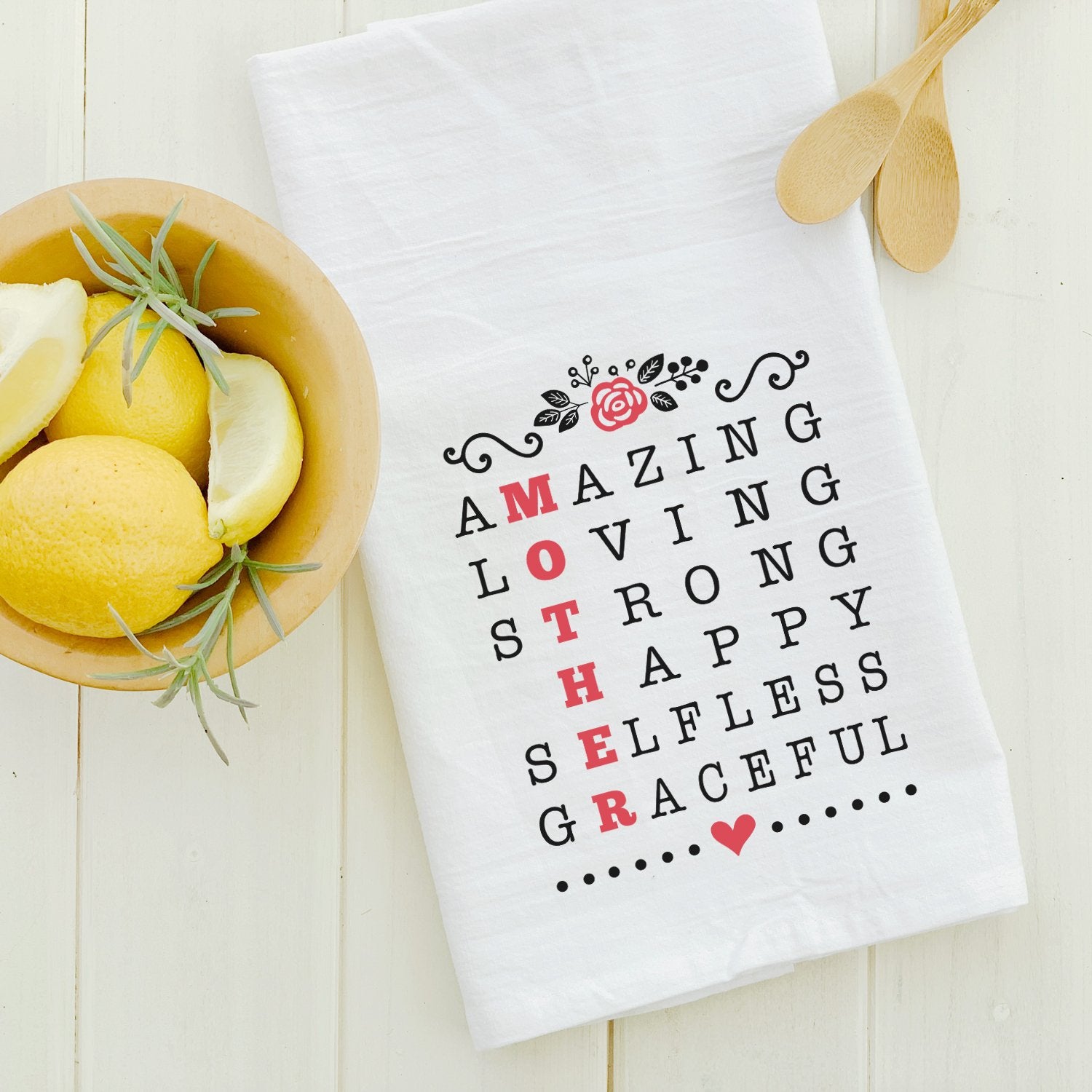 A vibrant cotton tea towel featuring a Mother Acrostic Poem design, showcasing its absorbent texture and hemmed edges.