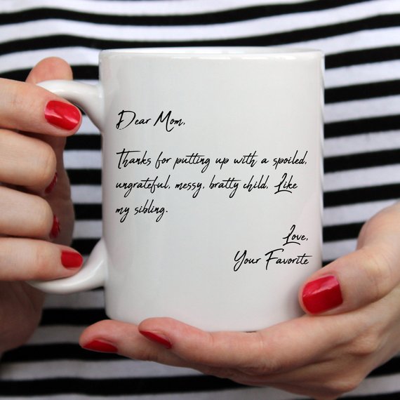 A humorous coffee mug with the text 'Dear Mom, Thanks 4 Putting Up With A S, Your Favorite', featuring a stylish design and a comfortable handle.