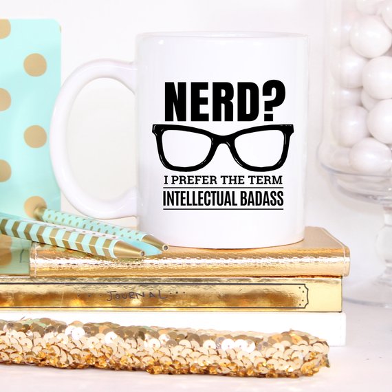 A humorous coffee mug featuring the phrase 'Nerd? I Prefer The Term Intellectual Badass' in bold lettering, showcasing a fun and quirky design.