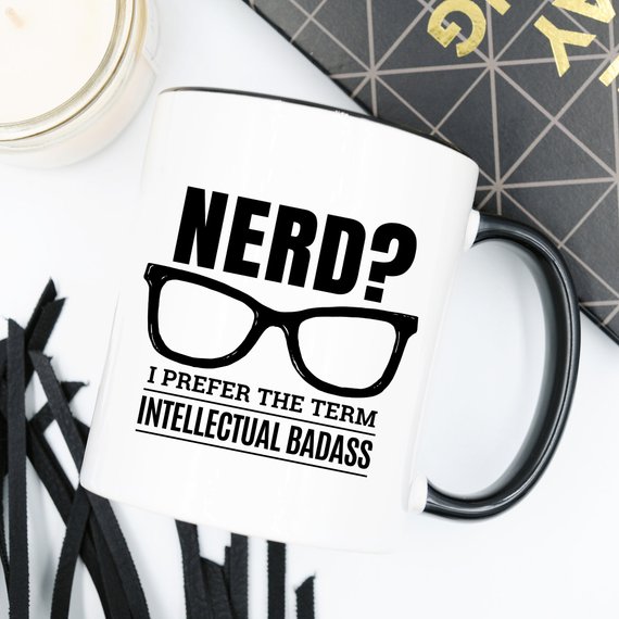 A humorous coffee mug featuring the phrase 'Nerd? I Prefer The Term Intellectual Badass' in bold lettering, showcasing a fun and quirky design.