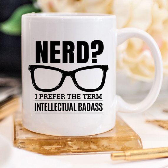 A humorous coffee mug featuring the phrase 'Nerd? I Prefer The Term Intellectual Badass' in bold lettering, showcasing a fun and quirky design.