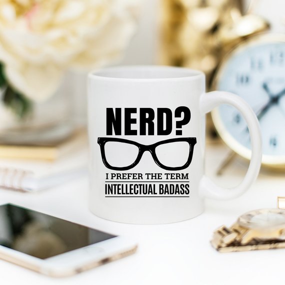 A humorous coffee mug featuring the phrase 'Nerd? I Prefer The Term Intellectual Badass' in bold lettering, showcasing a fun and quirky design.