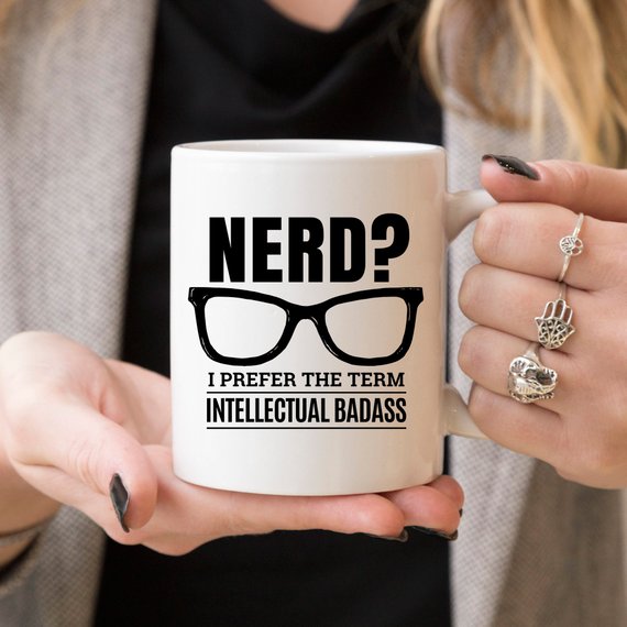 A humorous coffee mug featuring the phrase 'Nerd? I Prefer The Term Intellectual Badass' in bold lettering, showcasing a fun and quirky design.