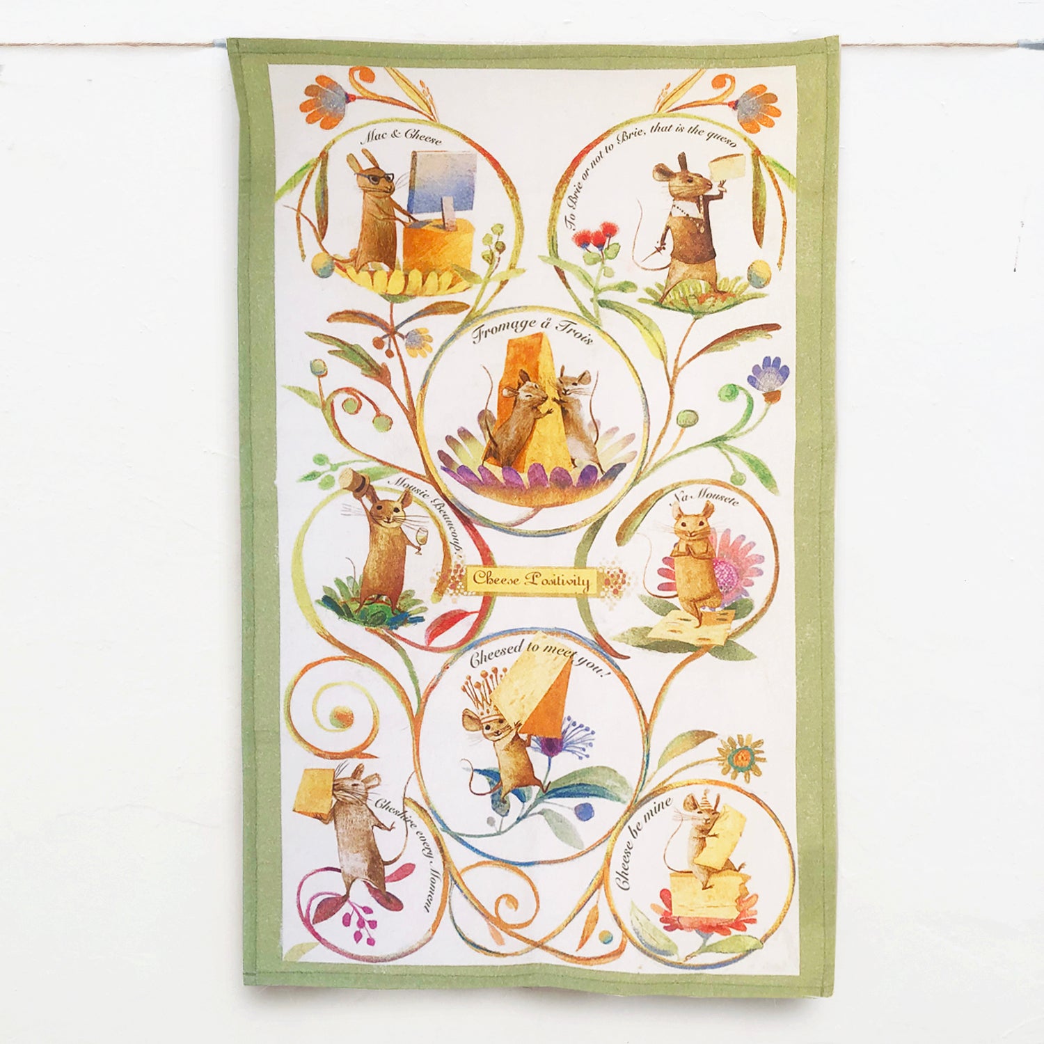 Cheese Positivity Tea Towel featuring vibrant cheese-themed design, made of 100% cotton with a corner loop for hanging.