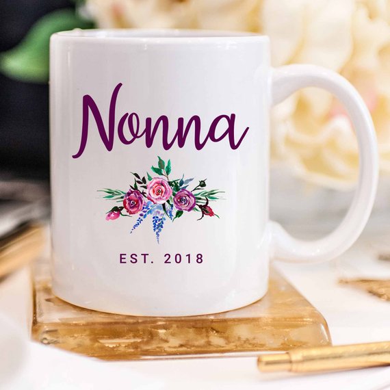 A white Nonna Mug made from high-grade ceramic, featuring a vibrant design printed on both sides, perfect for coffee lovers.