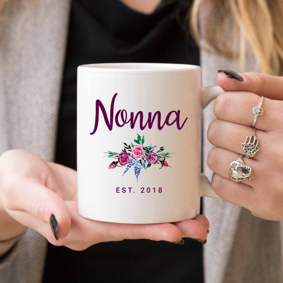 A white Nonna Mug made from high-grade ceramic, featuring a vibrant design printed on both sides, perfect for coffee lovers.