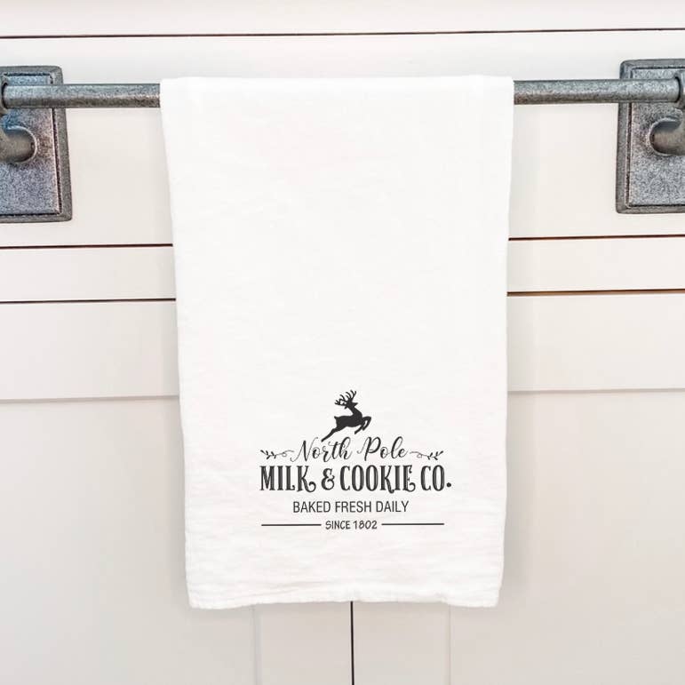 North Pole Milk & Cookies Cotton Tea Towel featuring a festive design, made from 100% absorbent cotton, perfect for holiday baking.