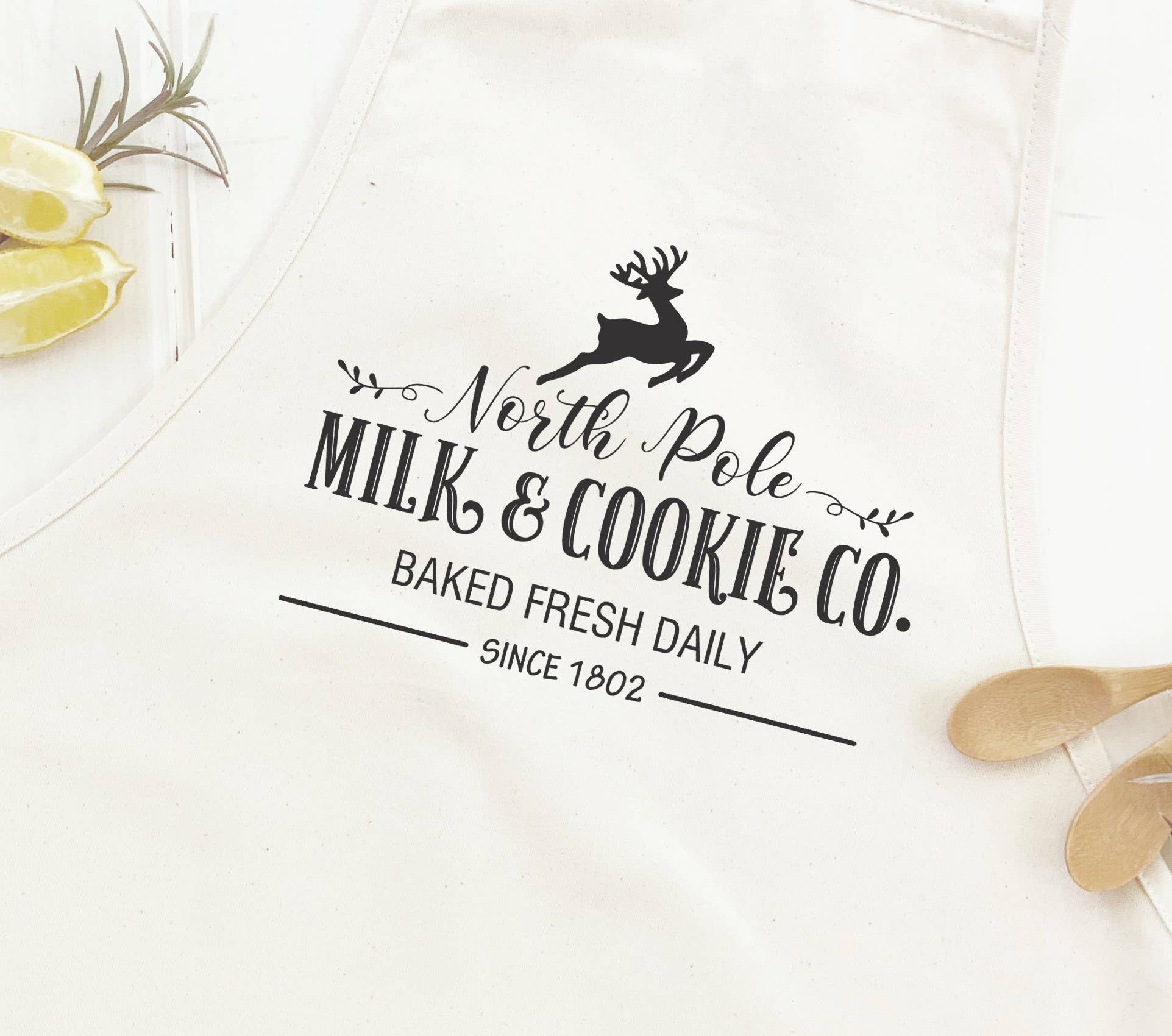 North Pole Milk & Cookies Women's Apron featuring elegant design, adjustable neck, and divided front pocket, made from durable cotton canvas.