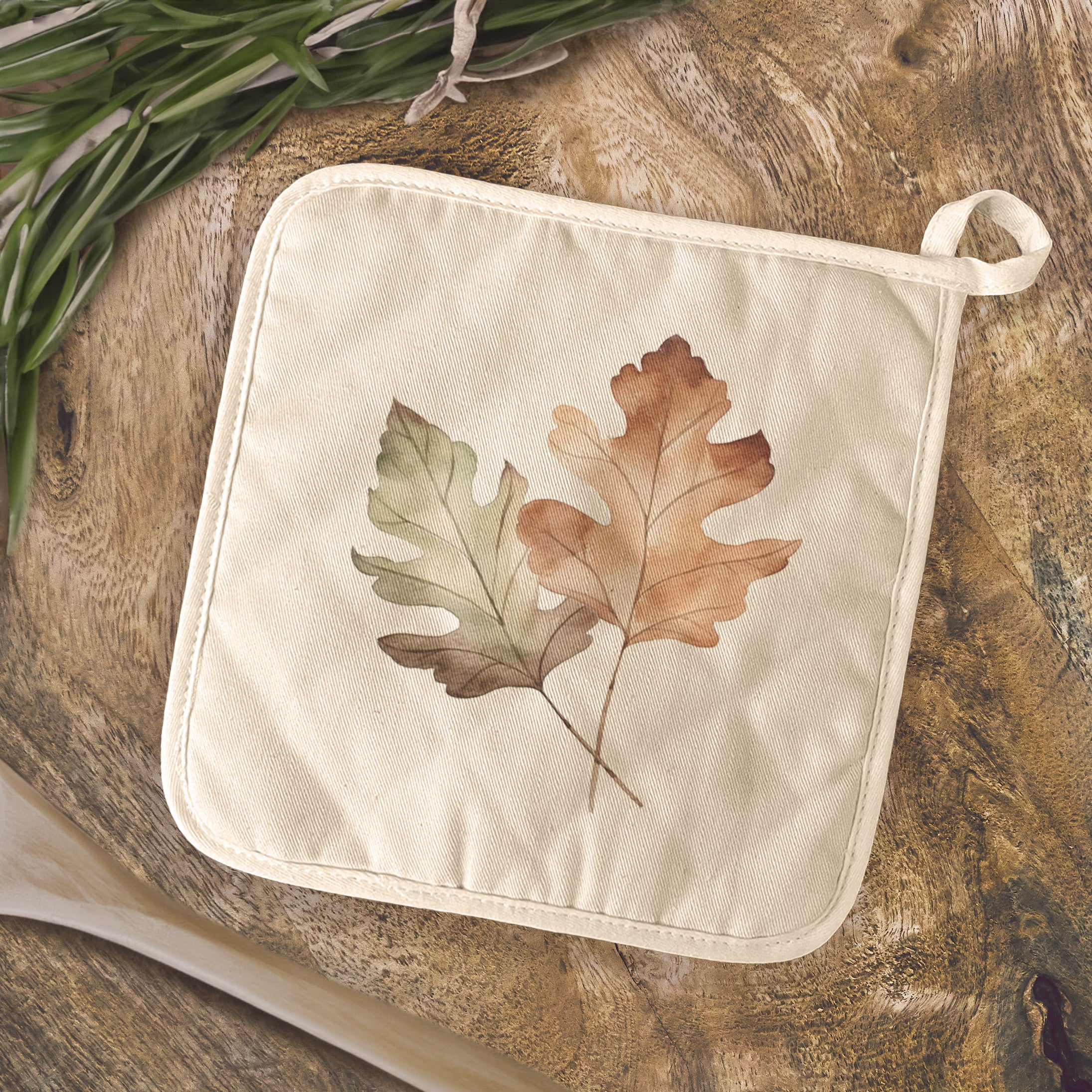 Oak Leaves Cotton Pot Holder featuring vibrant designs and a convenient hanging loop, perfect for protecting surfaces from hot cookware.