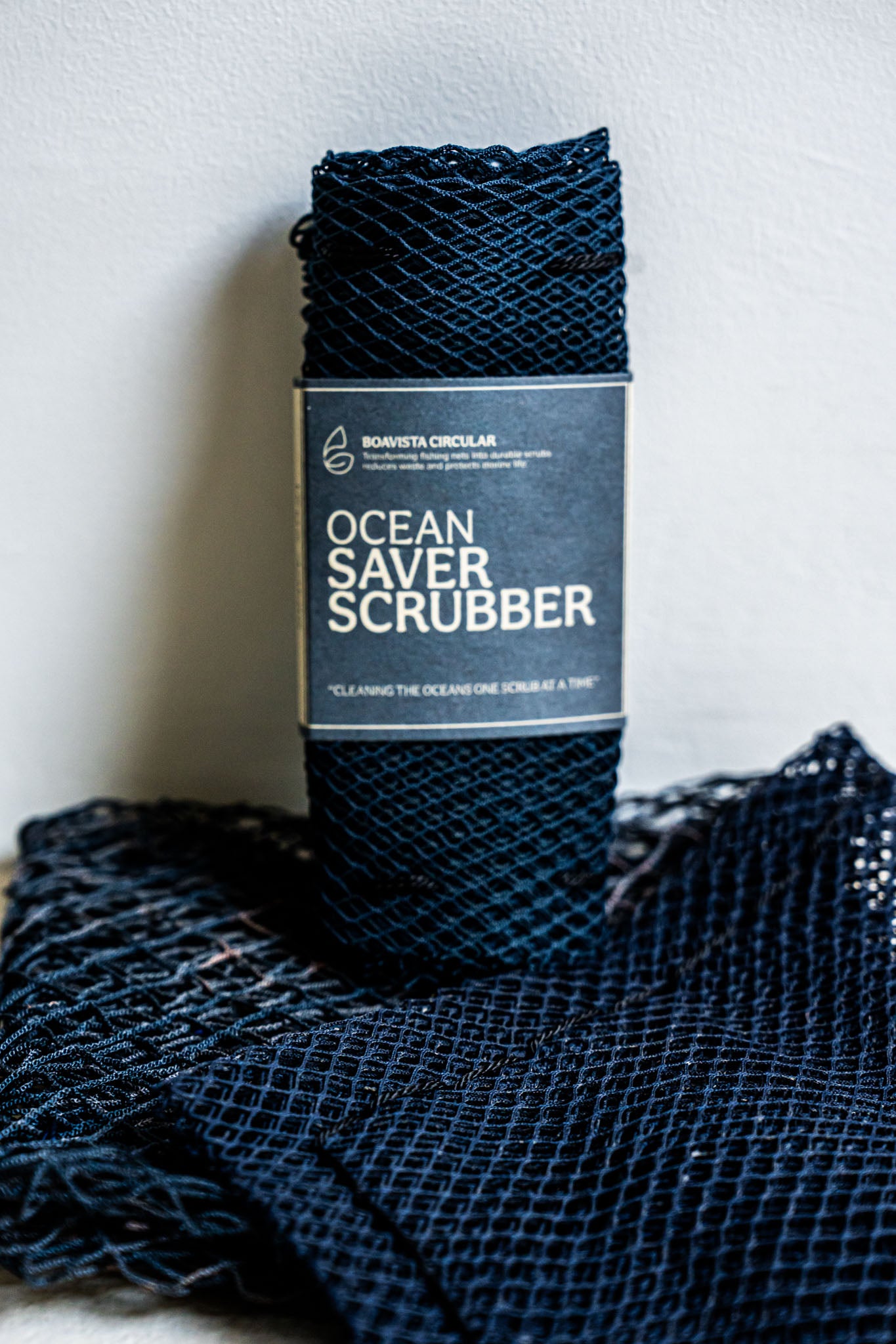 Ocean Saver Scrubber/Sponge made from recycled fishing nets, showcasing its unique texture and handcrafted design.