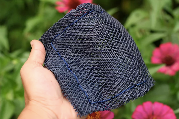 Ocean Saver Scrubber/Sponge made from recycled fishing nets, showcasing its unique texture and handcrafted design.