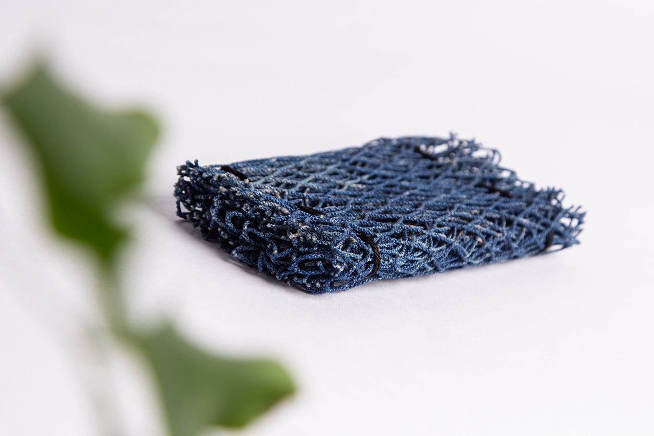 Ocean Saver Scrubber/Sponge made from recycled fishing nets, showcasing its unique texture and handcrafted design.