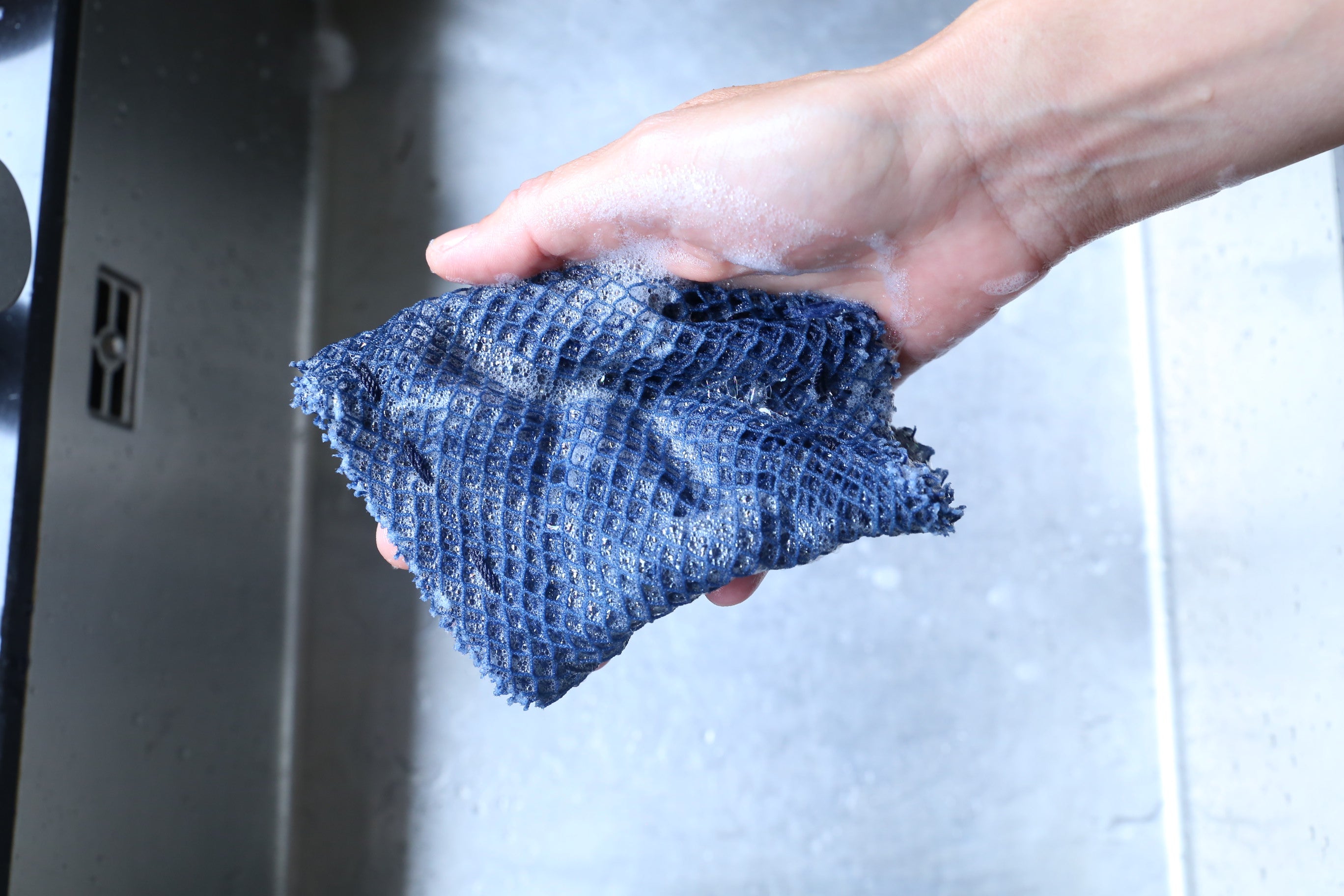 Ocean Saver Scrubber/Sponge made from recycled fishing nets, showcasing its unique texture and handcrafted design.