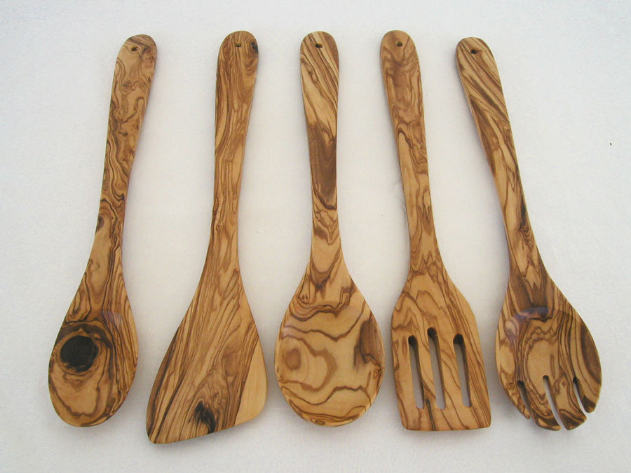 Five-piece olive wood kitchen utensil set including a sauce spoon, spoon, spork, cooking spoon, and spatula, showcasing their hand-carved details.