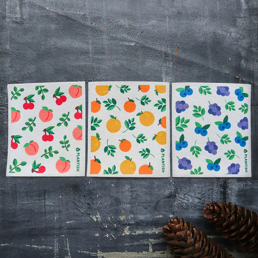 Orange Swedish Sponge Cloth with a vibrant citrus print, perfect for eco-friendly cleaning.