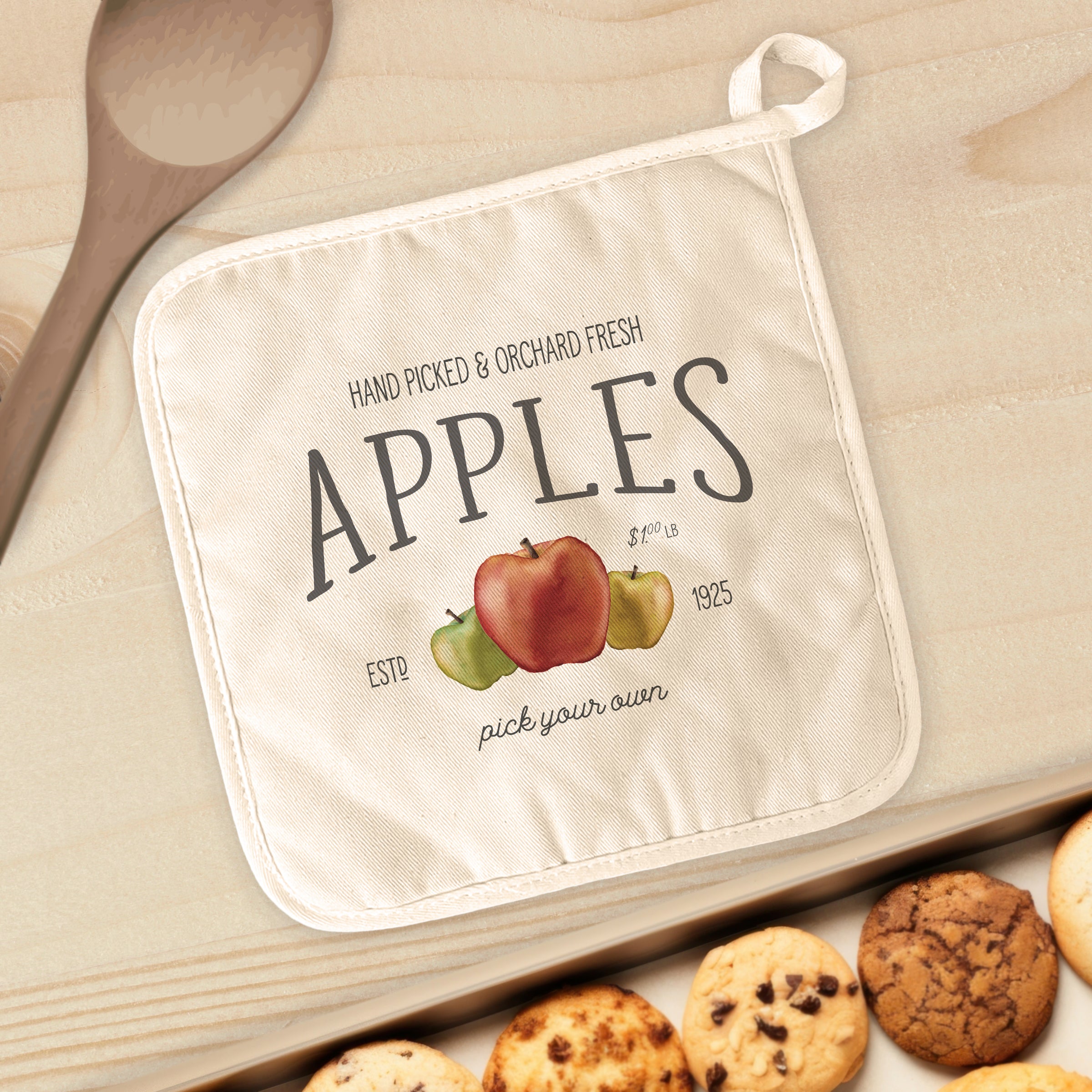 Orchard Fresh Apples cotton pot holder featuring vibrant apple designs and a convenient hanging loop.