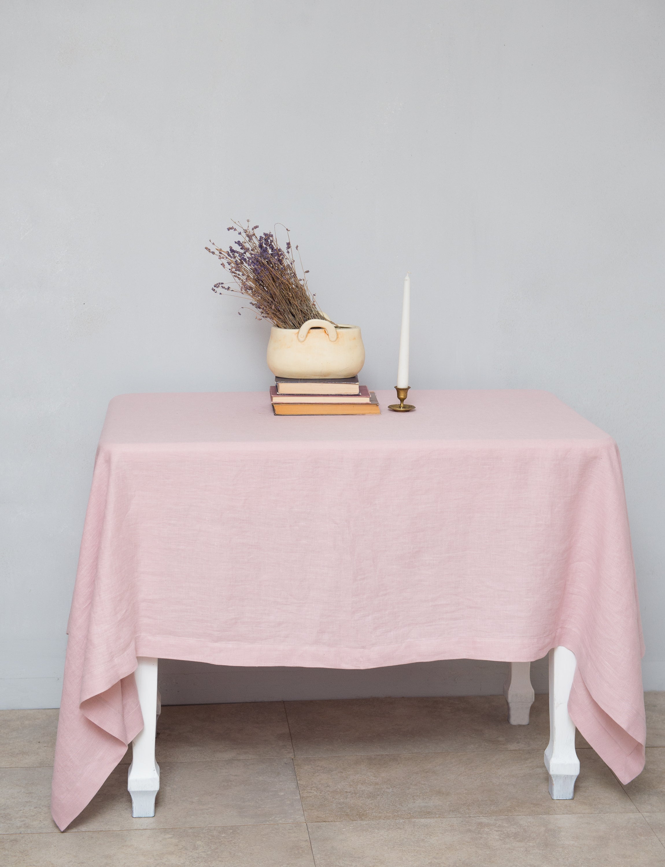 Pale Pink linen tablecloth draped elegantly over a dining table, showcasing its soft texture and luxurious appearance.