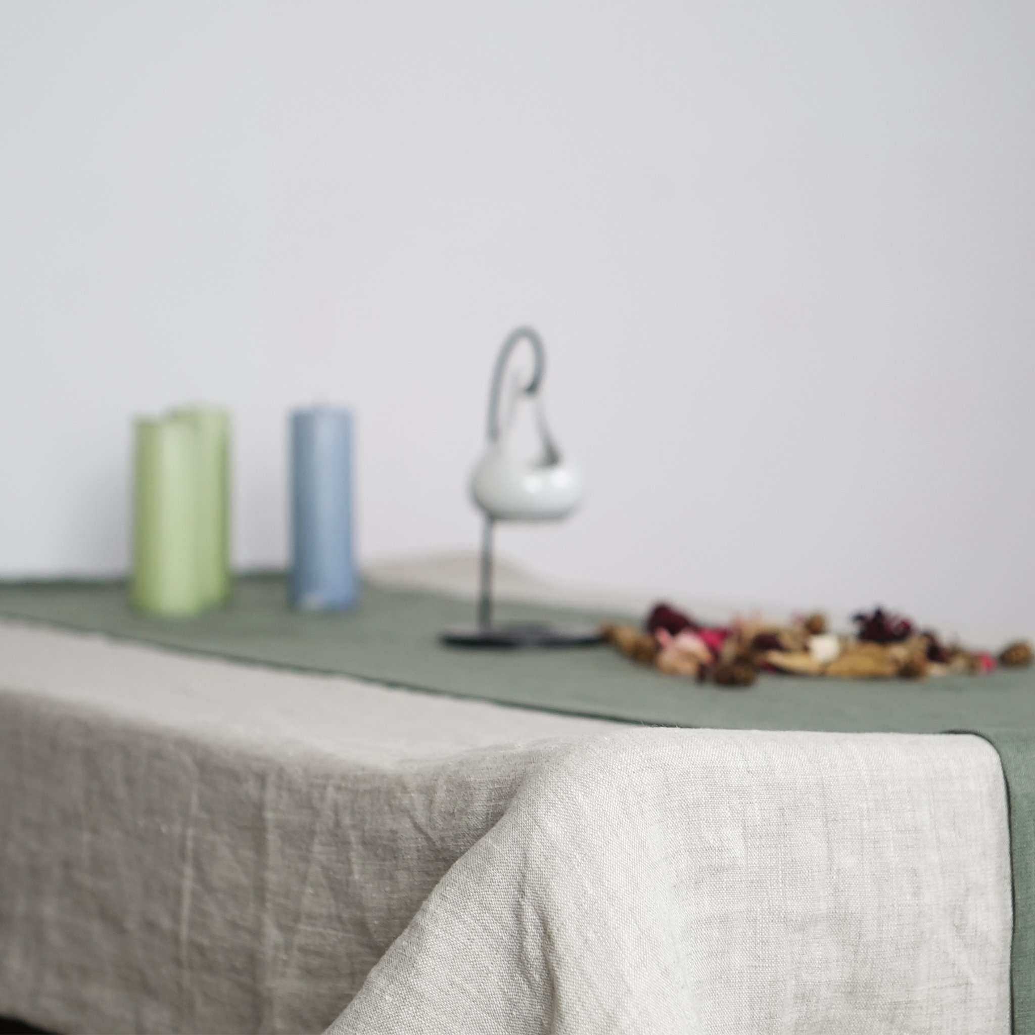 Pale Pink linen tablecloth draped elegantly over a dining table, showcasing its soft texture and luxurious appearance.